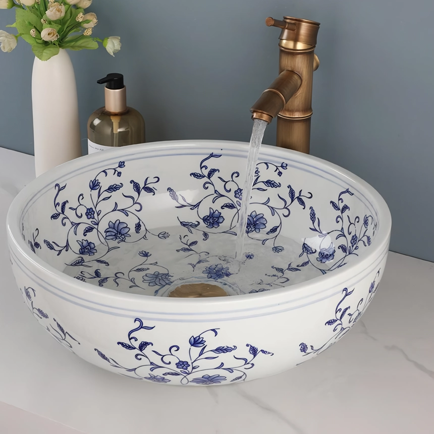 Transform your bathroom or kitchen with the timeless beauty of our Hand-Painted Ceramic Basin Sink. Featuring a traditional Chinese blue and white floral design, this exquisite sink adds sophistication and charm to any space. Crafted from high-quality ceramic and fired at 1300 degrees, this durable and easy-to-clean sink will remain a striking centerpiece in your home for years to come.