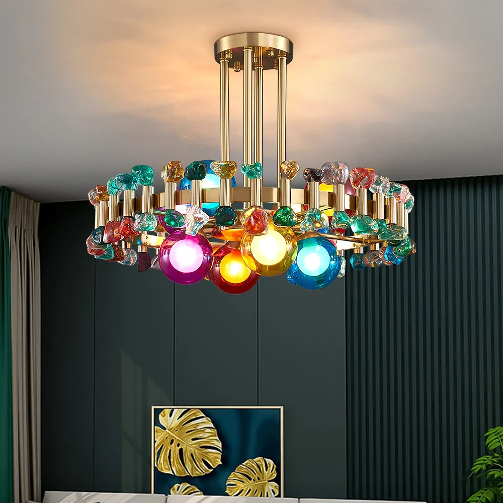 Transform your space with the Gold Round Modern Chandelier, a striking blend of elegance and modern design. Featuring a sleek gold finish and colorful stones that reflect light beautifully, this chandelier adds sophistication to any room. Perfect for living rooms, kitchens, dining areas, or bedrooms, it creates a warm, inviting ambiance. With included bulbs and hassle-free installation, it's ready to enhance your home decor immediately. Certified for safety and durability, this chandelier is the ideal statement piece to elevate your living space.
