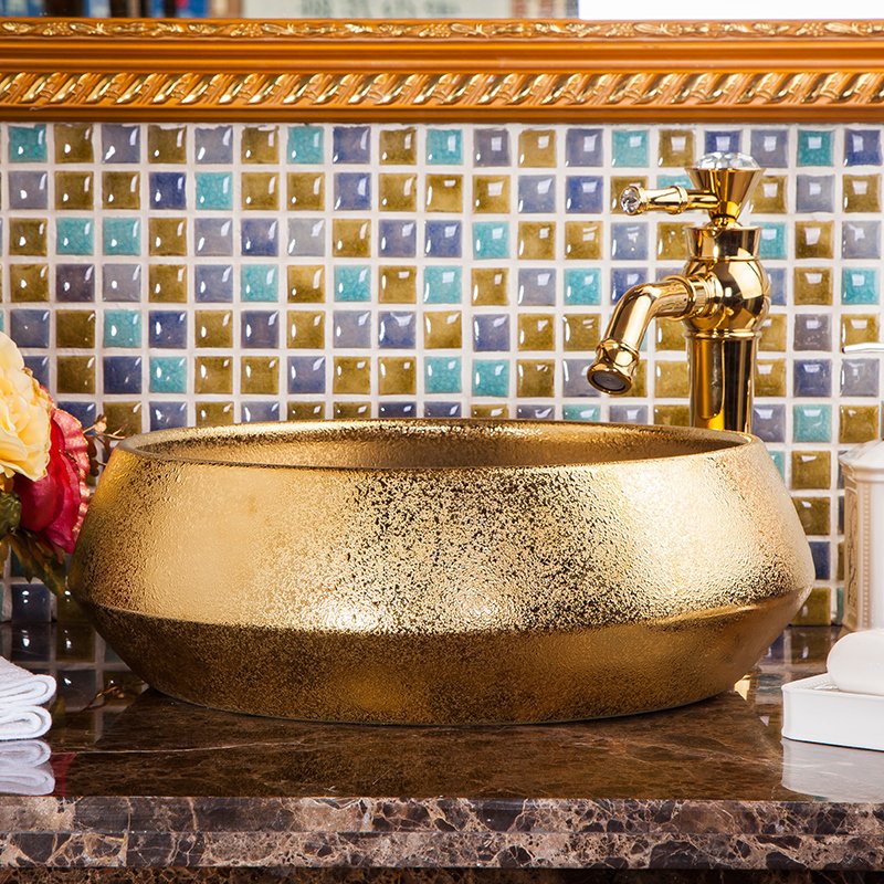 Elevate your bathroom with our Luxury Gold Glazed Ceramic Bathroom Basin, a stunning hand-made vessel sink that exudes elegance and sophistication. Featuring a luxurious gold glaze finish and unique oval shape, this high-quality ceramic basin is designed to add a touch of opulence to any bathroom. Its durable, easy-to-clean surface ensures lasting beauty, while its versatile design complements both contemporary and traditional decor styles. Make a statement with this exquisite bathroom upgrade—order yours today and transform your space into a luxurious retreat.