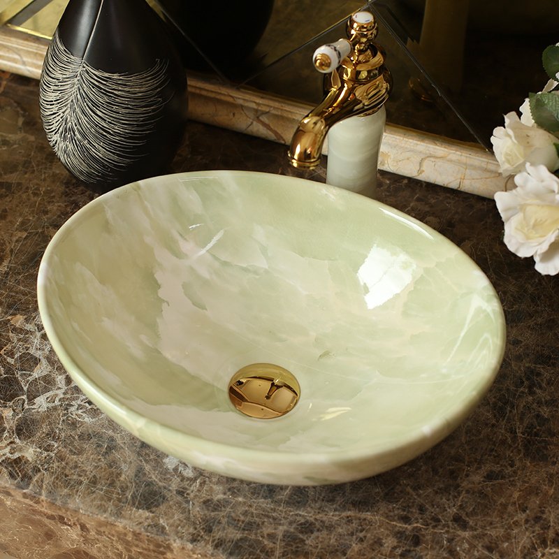 Elevate your bathroom or balcony with the Elegant Blue Ceramic Basin, designed to bring a touch of luxury and modern Nordic style to your home. With its glossy metal glaze finish and serene blue hue, this basin offers both beauty and practicality. Crafted from high-quality ceramic, it features an oval shape with a generous 12-liter capacity, making it perfect for a stylish and functional wash area. Ideal for both indoor and outdoor use, this versatile basin is easy to clean and maintain, ensuring long-lasting elegance in any setting.