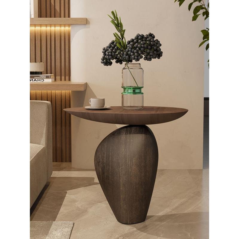 b6677a6c33530d3ba1de19aab0dea581.jpeg-full Bring modern elegance to your home with the Nordic Creative Cobblestone Side Table. Crafted from high-quality resin, this handmade piece mimics the natural beauty of cobblestones, adding a unique and artistic touch to your space. Its versatile design fits perfectly in living rooms, studies, or bedrooms, offering both style and functionality. Available in black or walnut, this table is a standout with its minimalist, Nordic-inspired look. Each handcrafted piece ensures no two are alike, making it a distinctive addition to your decor. Perfect as a decorative accent or a thoughtful gift, this side table brings both charm and durability to any room.