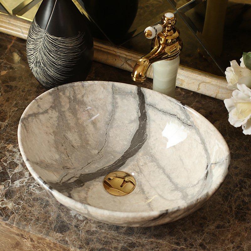 Elevate your bathroom or balcony with the Elegant Blue Ceramic Basin, designed to bring a touch of luxury and modern Nordic style to your home. With its glossy metal glaze finish and serene blue hue, this basin offers both beauty and practicality. Crafted from high-quality ceramic, it features an oval shape with a generous 12-liter capacity, making it perfect for a stylish and functional wash area. Ideal for both indoor and outdoor use, this versatile basin is easy to clean and maintain, ensuring long-lasting elegance in any setting.