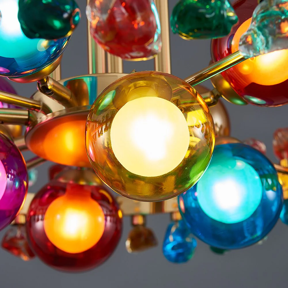 Transform your space with the Gold Round Modern Chandelier, a striking blend of elegance and modern design. Featuring a sleek gold finish and colorful stones that reflect light beautifully, this chandelier adds sophistication to any room. Perfect for living rooms, kitchens, dining areas, or bedrooms, it creates a warm, inviting ambiance. With included bulbs and hassle-free installation, it's ready to enhance your home decor immediately. Certified for safety and durability, this chandelier is the ideal statement piece to elevate your living space.