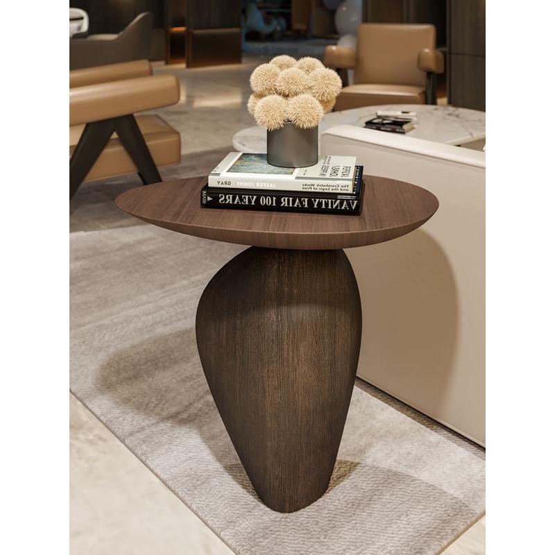 ecf3ead5f61b72042aa049d3c0f4f9c1.jpeg-full Bring modern elegance to your home with the Nordic Creative Cobblestone Side Table. Crafted from high-quality resin, this handmade piece mimics the natural beauty of cobblestones, adding a unique and artistic touch to your space. Its versatile design fits perfectly in living rooms, studies, or bedrooms, offering both style and functionality. Available in black or walnut, this table is a standout with its minimalist, Nordic-inspired look. Each handcrafted piece ensures no two are alike, making it a distinctive addition to your decor. Perfect as a decorative accent or a thoughtful gift, this side table brings both charm and durability to any room.