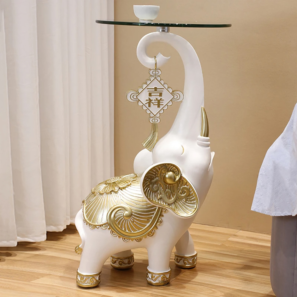16d66b971d59ba52df35b246b54cef7a The Resin Elephant Glass Top Coffee Table is a stunning fusion of art and functionality, designed to be the centerpiece of any room. Featuring a lifelike elephant base crafted from premium resin and topped with durable tempered glass, this table adds a touch of elegance and creativity to your space. Available in two sizes, it serves as both a functional coffee table and a stylish storage solution. Perfect for living rooms, commercial spaces, or eclectic décor themes, this semi-handmade table is not just furniture—it's a conversation starter and a true work of art. Elevate your space with this unique and captivating piece!