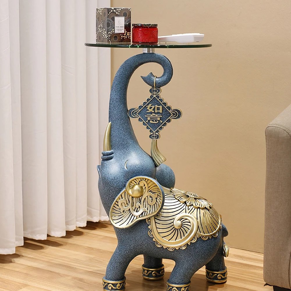 39a048dc501a1b53cf8a82cf553d236d.jpg-full The Resin Elephant Glass Top Coffee Table is a stunning fusion of art and functionality, designed to be the centerpiece of any room. Featuring a lifelike elephant base crafted from premium resin and topped with durable tempered glass, this table adds a touch of elegance and creativity to your space. Available in two sizes, it serves as both a functional coffee table and a stylish storage solution. Perfect for living rooms, commercial spaces, or eclectic décor themes, this semi-handmade table is not just furniture—it's a conversation starter and a true work of art. Elevate your space with this unique and captivating piece!