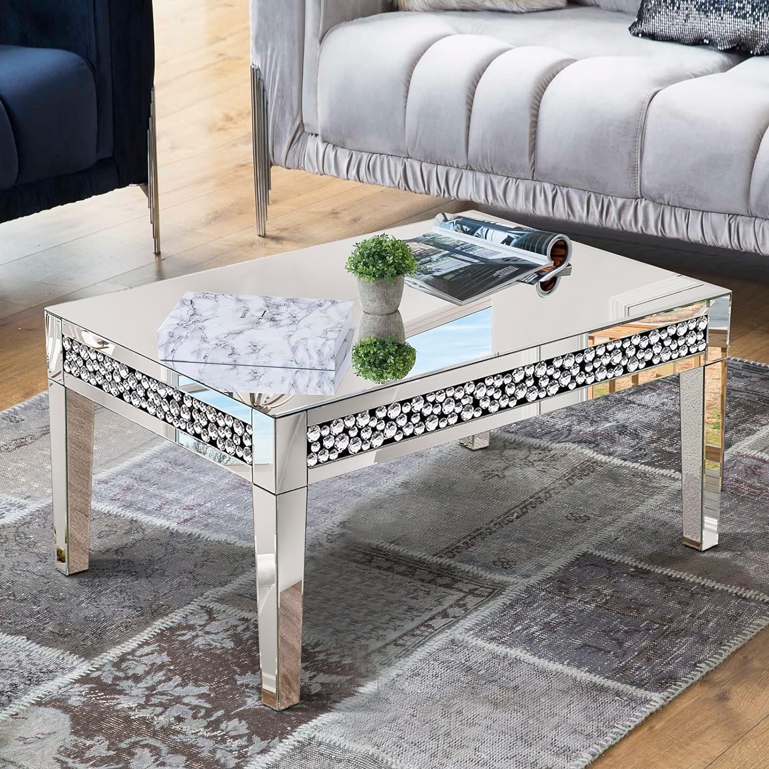 Elevate your space with the Luxury Rectangular Mirror Coffee Table, a stunning blend of modern sophistication and minimalist design. Crafted with high-quality silver mirror glass and adorned with crystal diamond inlays, this table reflects light, brightening any room while adding a touch of glamour. Its durable MDF frame ensures longevity, and the easy assembly process makes it a hassle-free addition to your home or office. Perfect for modern interiors, this table combines functionality with luxurious style, making it an ideal centerpiece for any living room, office, or boutique.