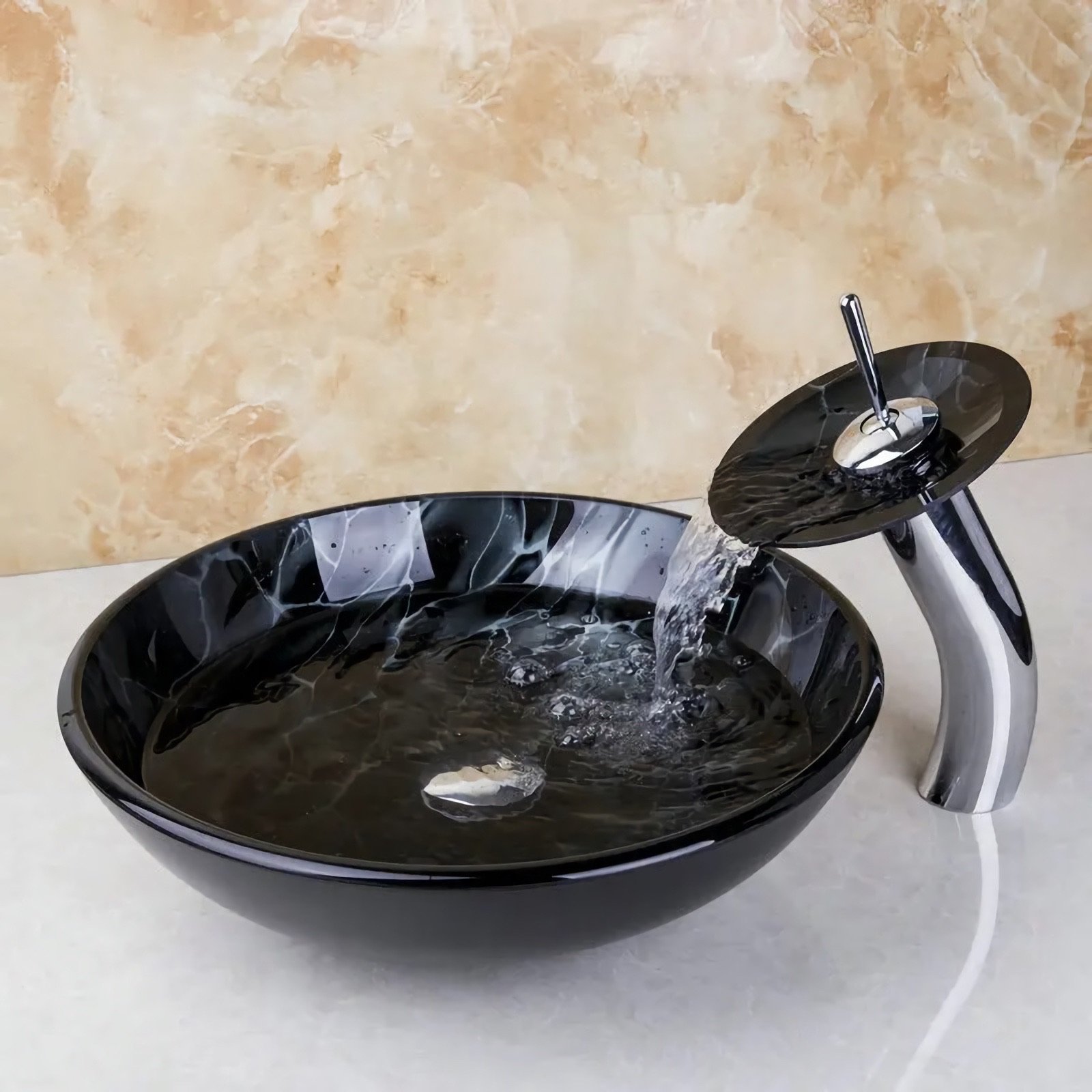 Elevate your bathroom with the Glass Vessel Sink Faucet Combo featuring a stunning waterfall faucet tap. Designed with sleek, European-inspired artistry, this oversized set combines luxury with functionality. The durable tempered glass construction ensures long-lasting quality, while the easy above-the-counter installation simplifies setup. Complete with a chrome pop-up drain for hassle-free maintenance, this combo adds elegance and a touch of luxury to any modern bathroom, making it the perfect choice for your next upgrade.