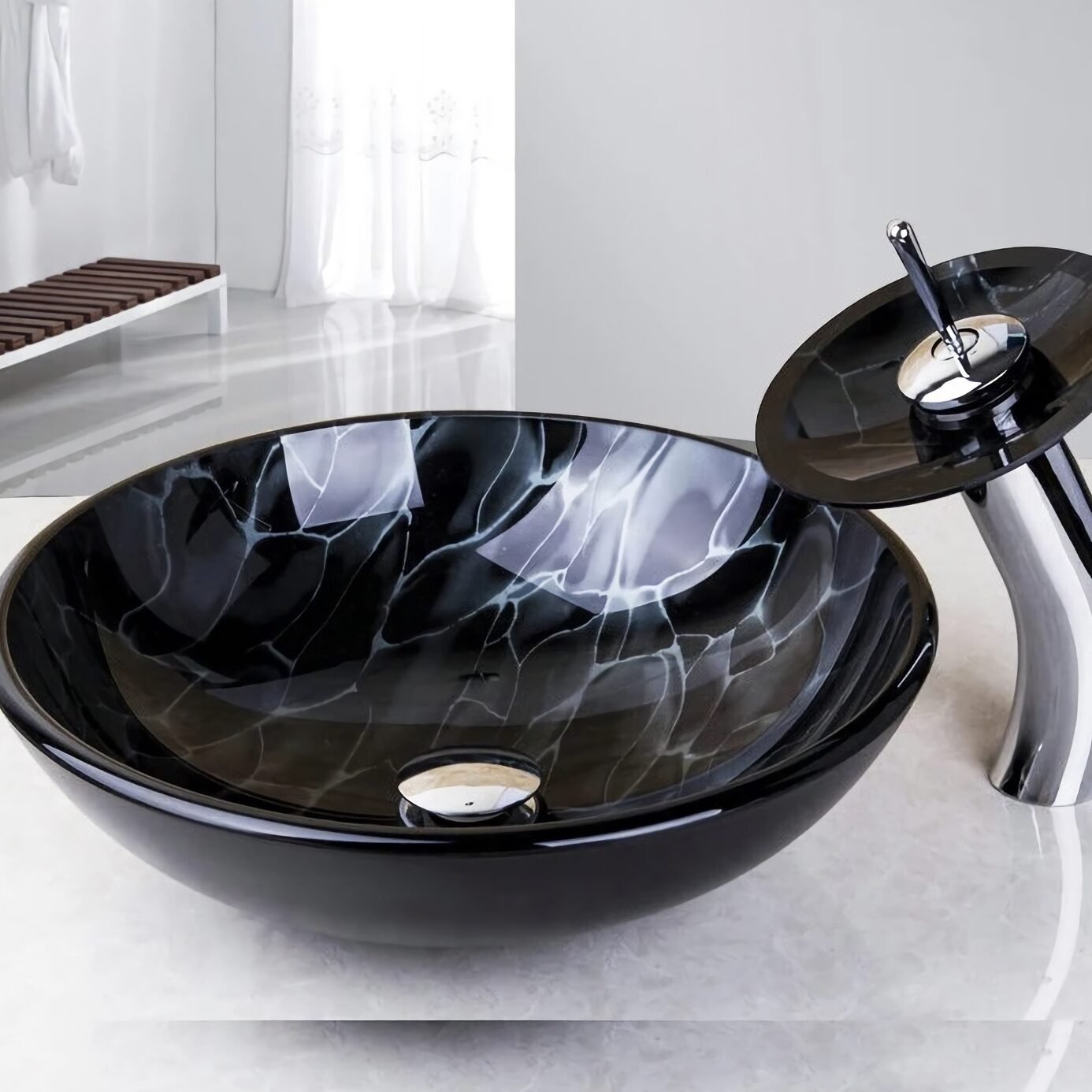 Elevate your bathroom with the Glass Vessel Sink Faucet Combo featuring a stunning waterfall faucet tap. Designed with sleek, European-inspired artistry, this oversized set combines luxury with functionality. The durable tempered glass construction ensures long-lasting quality, while the easy above-the-counter installation simplifies setup. Complete with a chrome pop-up drain for hassle-free maintenance, this combo adds elegance and a touch of luxury to any modern bathroom, making it the perfect choice for your next upgrade.