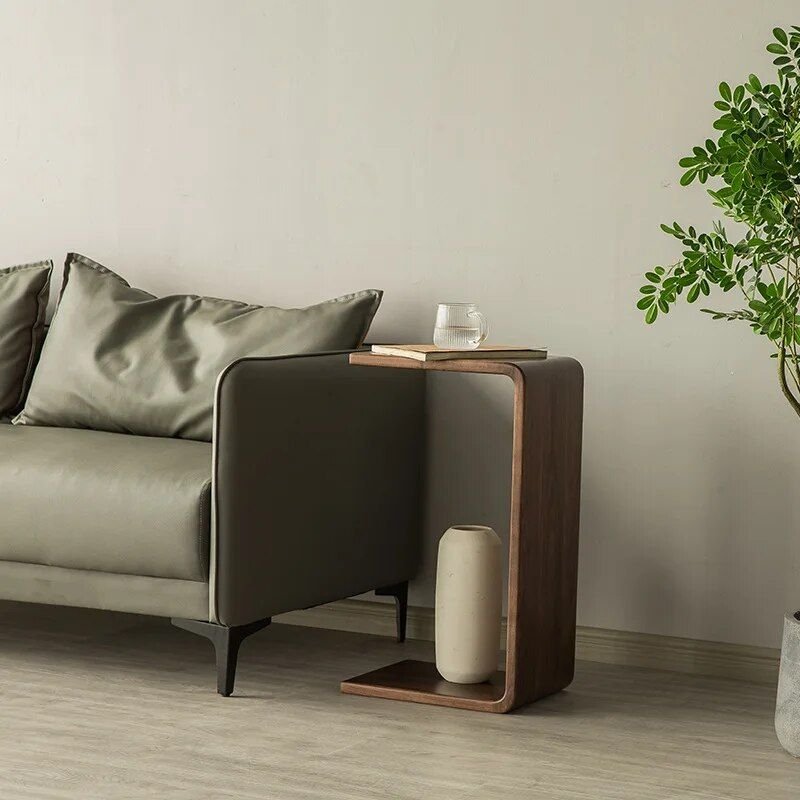 2dc5052e4ef4b3c163e4ca9e432dfe1b.jpg-full The Modern Walnut Coffee Table combines luxury and functionality in a sleek, minimalist design. Crafted from high-quality eco-friendly black walnut, it offers natural elegance with a durable and fine texture. The versatile C-shaped design allows it to function as both a stylish coffee table and a convenient side table, making it ideal for living rooms, bedrooms, or offices. Lightweight and easy to move, this table’s compact size (62x25x35cm) suits any space, adding a touch of European-American style to your decor. Elevate your home or office with this multifunctional piece that blends modern simplicity with timeless luxury.