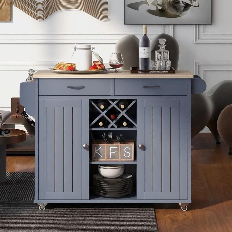 3fcfe8c40342dc4a6fef98d7241a629f.jpeg-full Elevate Your Culinary Space with our Multi-Purpose Kitchen Island Cart. This stylish and functional piece is perfect for any kitchen, dining room, or hallway. Featuring ample storage with two easy-glide drawers, large cabinets, open shelves, and a built-in wine rack for five bottles, it provides both organization and display space. The four smooth-rolling wheels make it easy to move, with lockable wheels for stability. Constructed from durable mahogany wood with a sleek, heat-resistant veneered top, this kitchen island cart combines elegance and practicality. Simple assembly and premium materials ensure long-lasting use. Order now and enhance your kitchen with this versatile, high-quality cart!