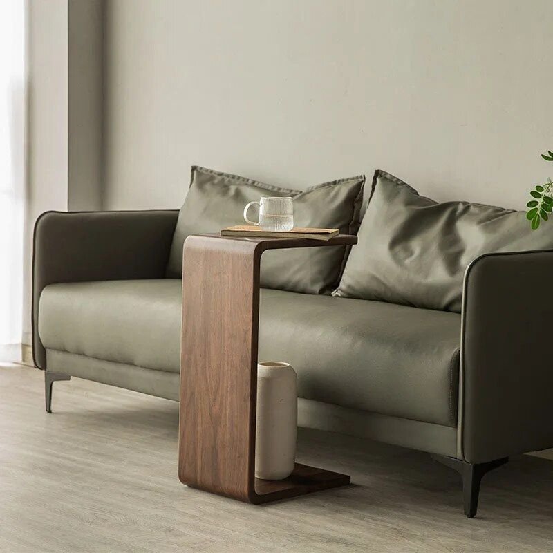 50c194266de034eae03866de237bf3ba.jpg-full The Modern Walnut Coffee Table combines luxury and functionality in a sleek, minimalist design. Crafted from high-quality eco-friendly black walnut, it offers natural elegance with a durable and fine texture. The versatile C-shaped design allows it to function as both a stylish coffee table and a convenient side table, making it ideal for living rooms, bedrooms, or offices. Lightweight and easy to move, this table’s compact size (62x25x35cm) suits any space, adding a touch of European-American style to your decor. Elevate your home or office with this multifunctional piece that blends modern simplicity with timeless luxury.