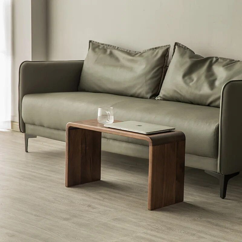 9ca1498482d2ed8d642c23520732727f.jpg-full The Modern Walnut Coffee Table combines luxury and functionality in a sleek, minimalist design. Crafted from high-quality eco-friendly black walnut, it offers natural elegance with a durable and fine texture. The versatile C-shaped design allows it to function as both a stylish coffee table and a convenient side table, making it ideal for living rooms, bedrooms, or offices. Lightweight and easy to move, this table’s compact size (62x25x35cm) suits any space, adding a touch of European-American style to your decor. Elevate your home or office with this multifunctional piece that blends modern simplicity with timeless luxury.