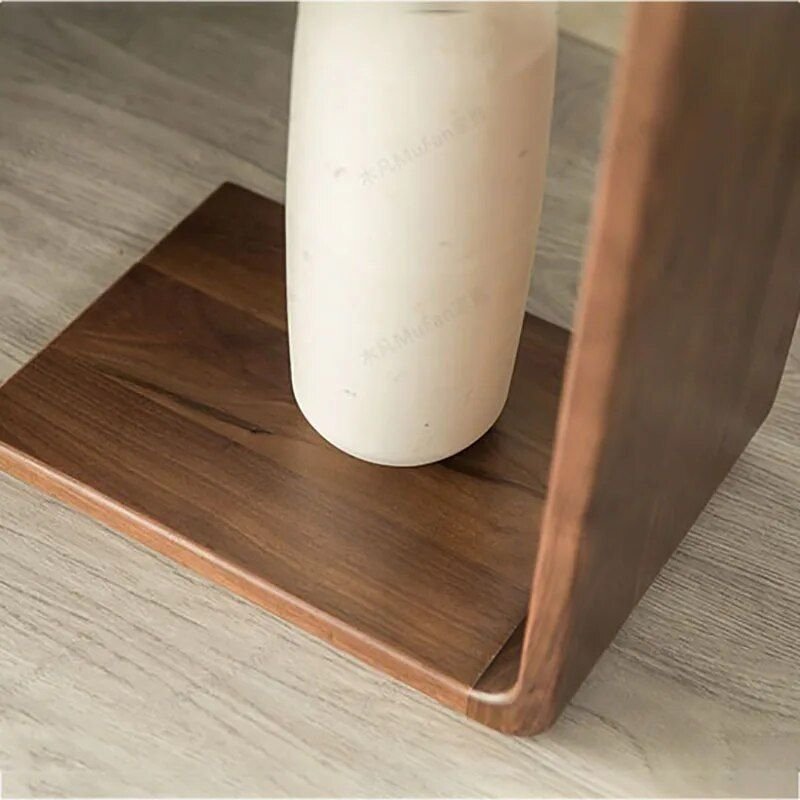 d1f23ae162c7bc400e52c084c504e0bf.jpg-full The Modern Walnut Coffee Table combines luxury and functionality in a sleek, minimalist design. Crafted from high-quality eco-friendly black walnut, it offers natural elegance with a durable and fine texture. The versatile C-shaped design allows it to function as both a stylish coffee table and a convenient side table, making it ideal for living rooms, bedrooms, or offices. Lightweight and easy to move, this table’s compact size (62x25x35cm) suits any space, adding a touch of European-American style to your decor. Elevate your home or office with this multifunctional piece that blends modern simplicity with timeless luxury.